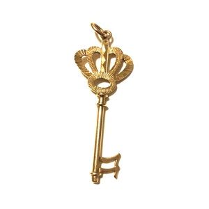 14kt vintage key charm with crown design at top.